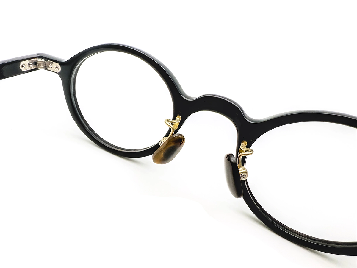 Buffalo horn eyewear with hinge and nose-pad hardware details