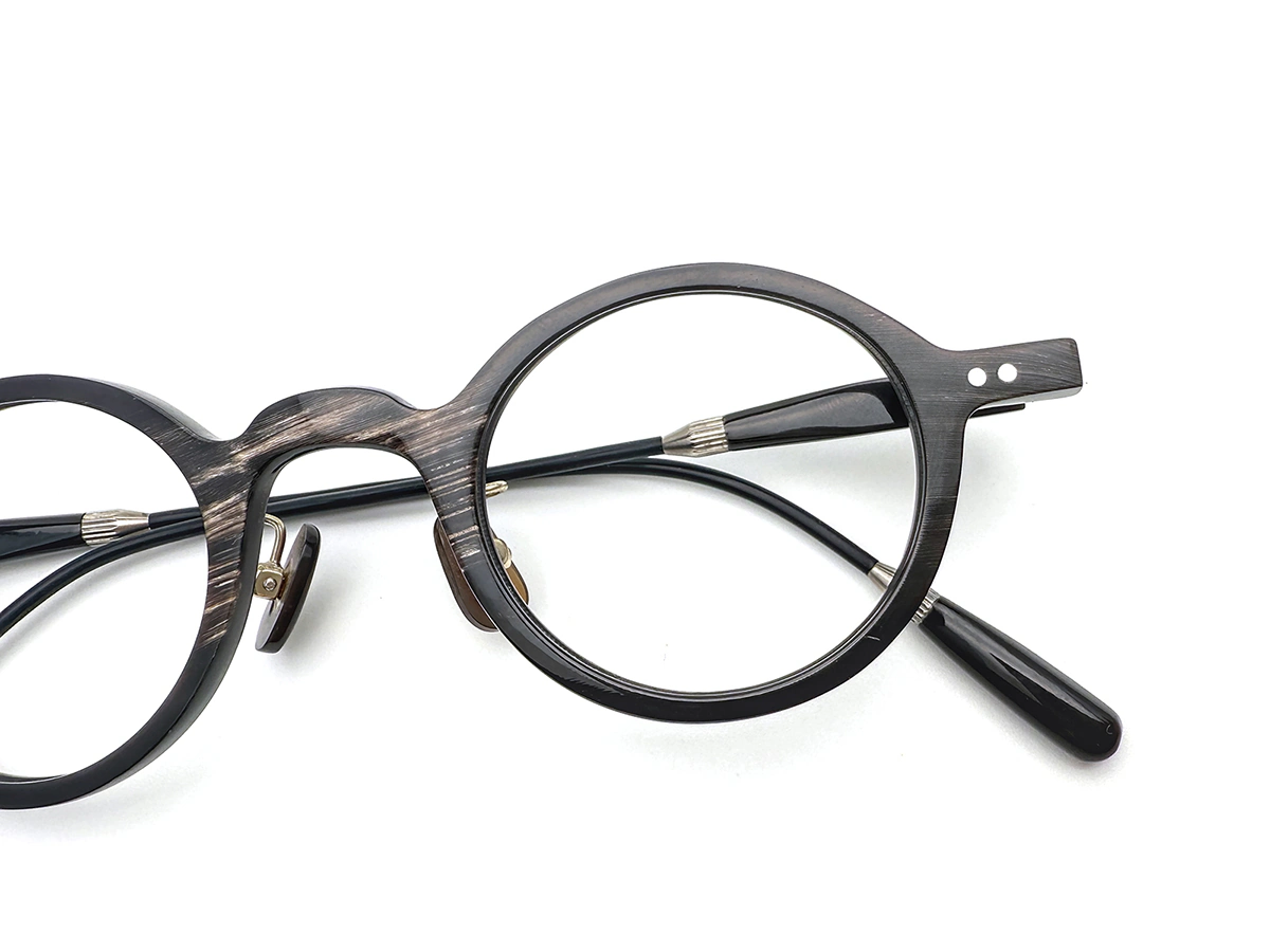 Mixed material eyewear combining buffalo horn with titanium components