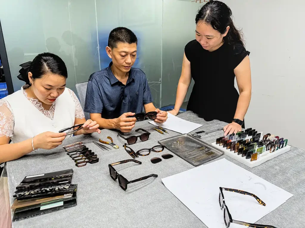 SEESUN eyewear development team reviewing frame samples, components and material options at the worktable