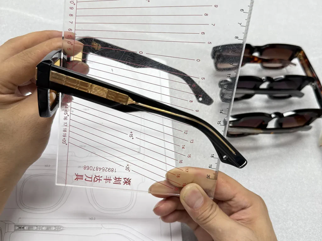 Eyewear frame alignment checked with a transparent angle gauge during manufacturing