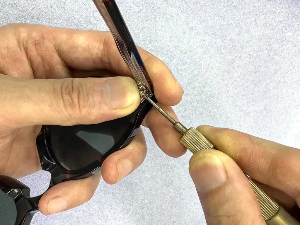 Hand assembly of custom acetate eyewear frames and temple hinges