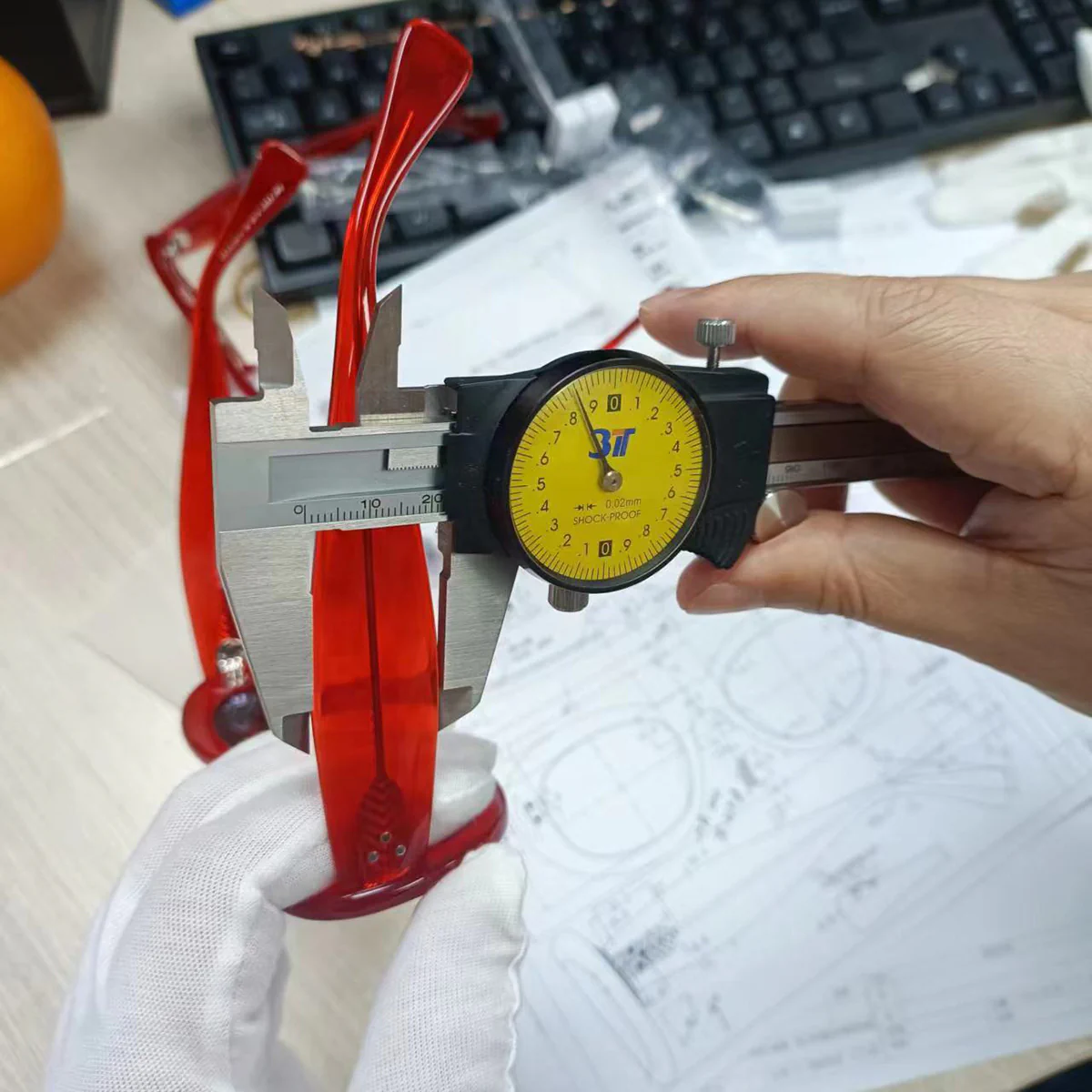 Eyewear sample dimensions checked against a technical drawing before production