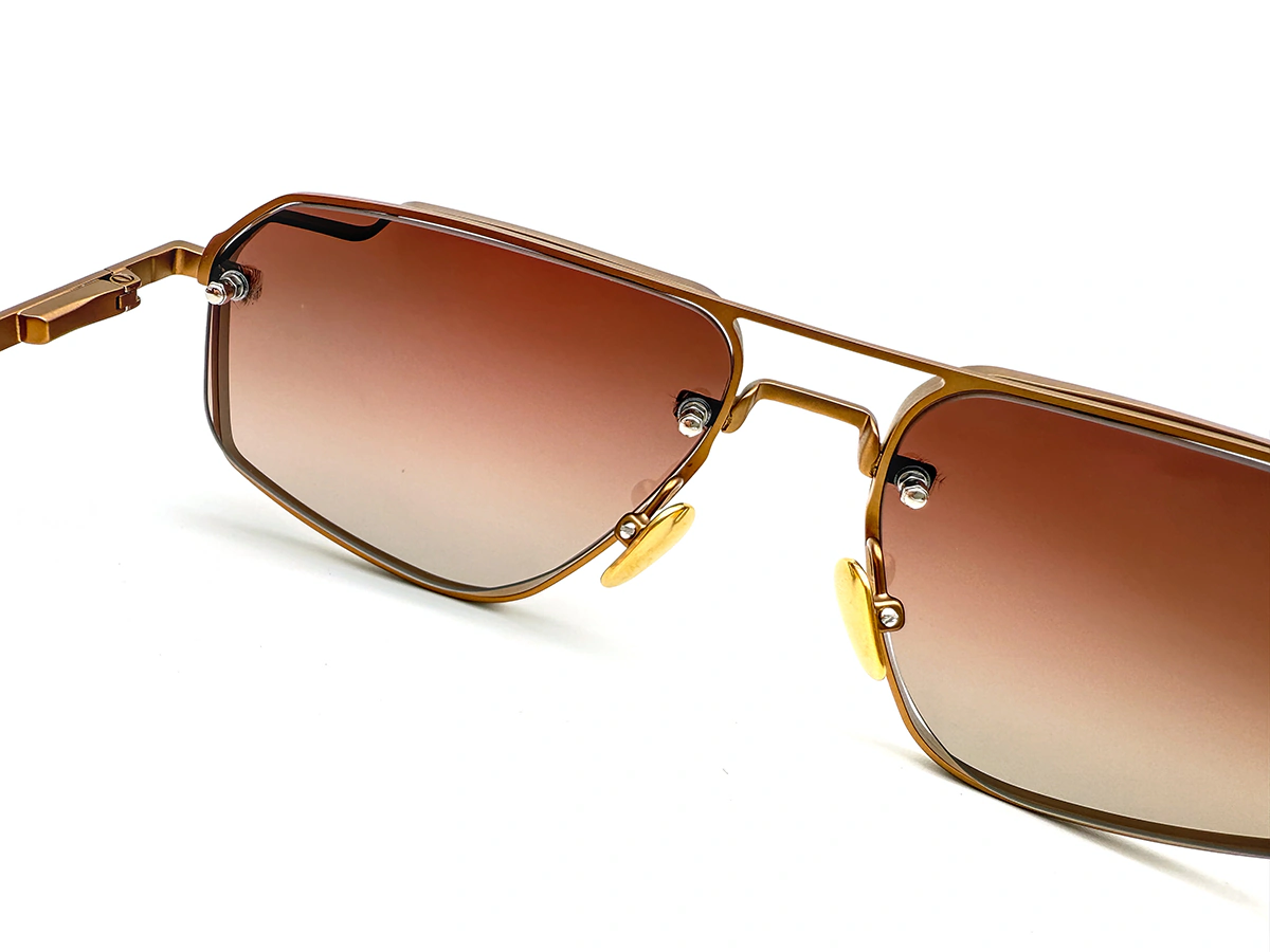 Metal sunglasses with exposed lens mounts and geometric bridge detail