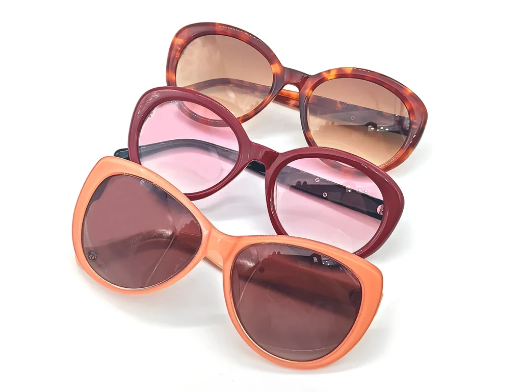 Three sunglasses in tortoiseshell, burgundy and peach frame colors with brown and pink-tinted lenses