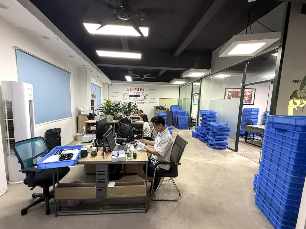 SEESUN eyewear manufacturing team working with frame samples and production trays