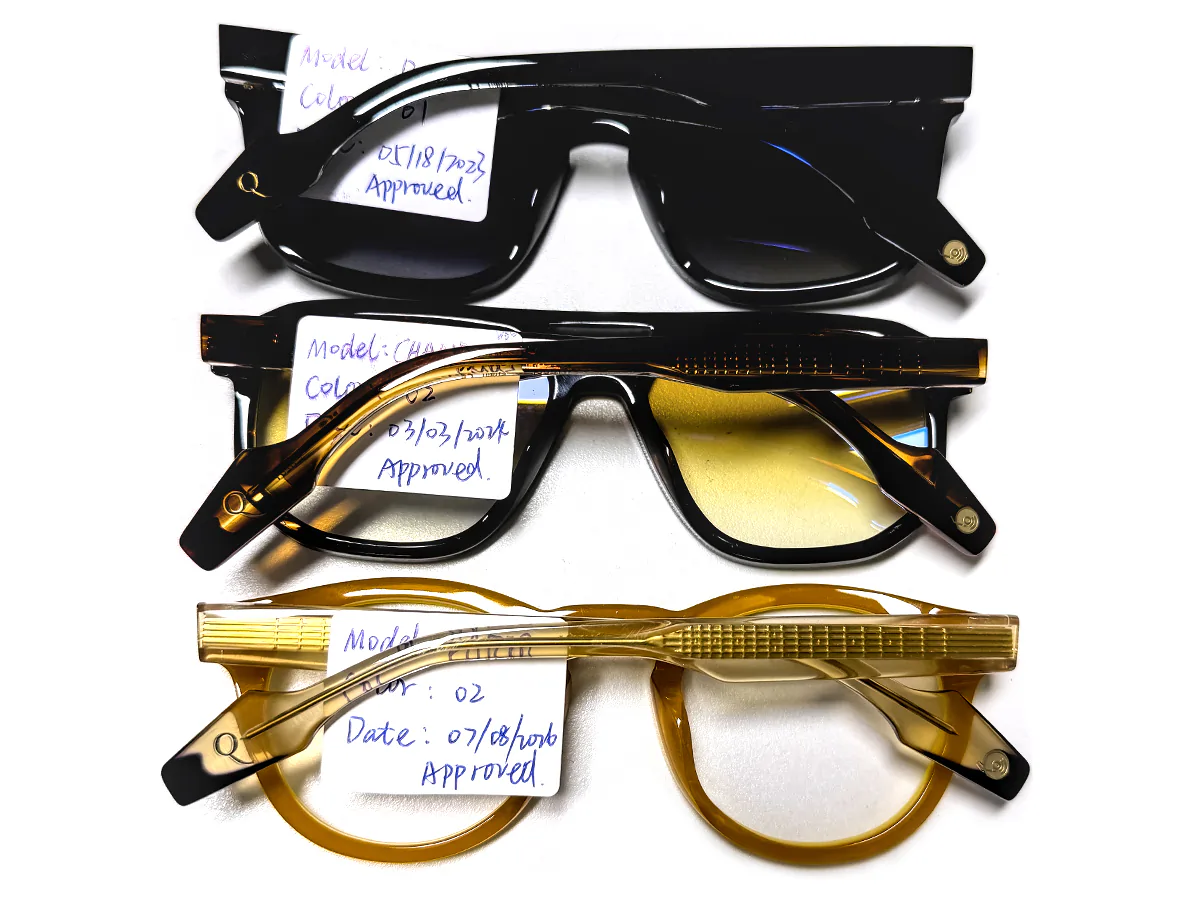 Approved Eyewear Reference Samples Three approved eyewear samples with handwritten approval tags on a white work surface