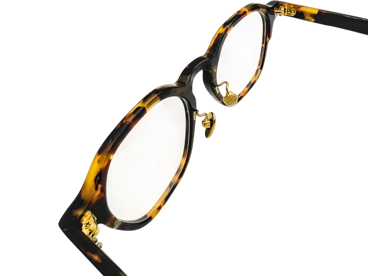 Tortoise optical frame with adjustable nose pads and open temple showing the hinge position